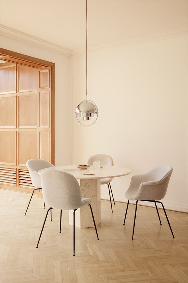 Gubi Epic Dining Table and Beetle and Bat Chairs in a neutral room