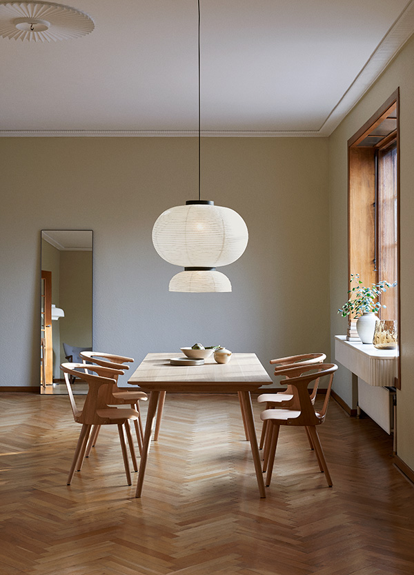 &Tradition SK dining table and chairs underneath a sculptural paper pendant light