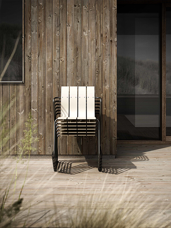 Mater ocean chairs stacked in front of wooden house