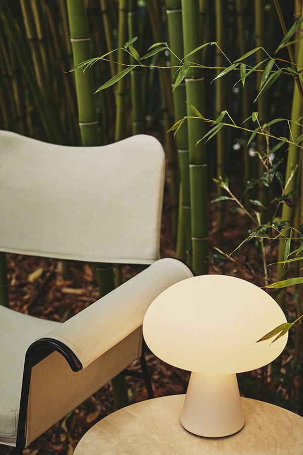 A Gubi Obello Outdoor Table Lamp on a side table
