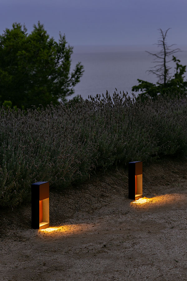 Two Marset Lab outdoor floor lamps illuminating a sand path