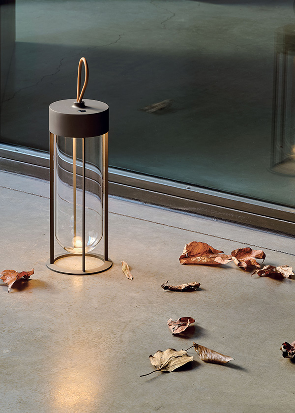 Flos In Vitro Unplugged Table Lamp on the floor next to fallen leaves