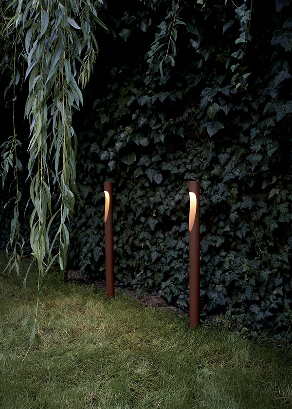2 Louis Poulsen Flindt Garden Bollard Floor Lamps next to some bushes
