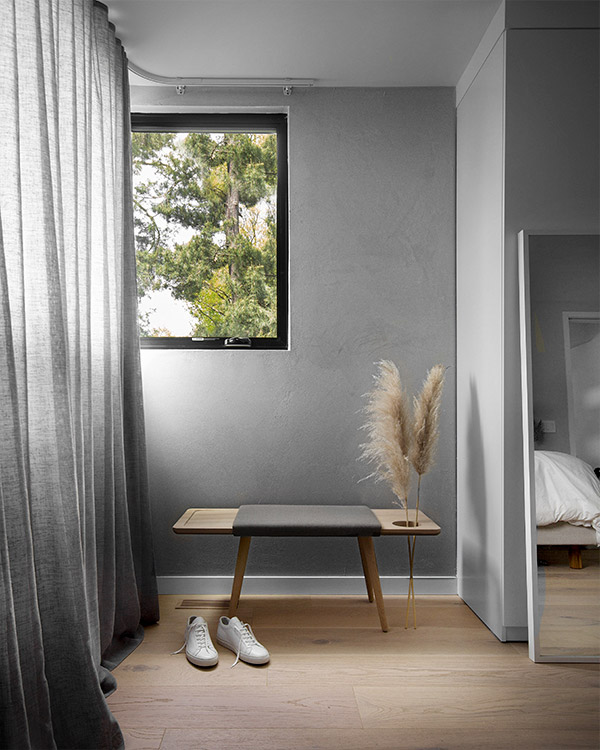 Woud baenk bench next to grey curtain