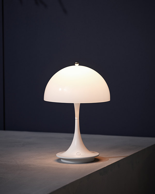 Close up of the Louis Poulsen Panthella Portable Table Lamp against a dark background