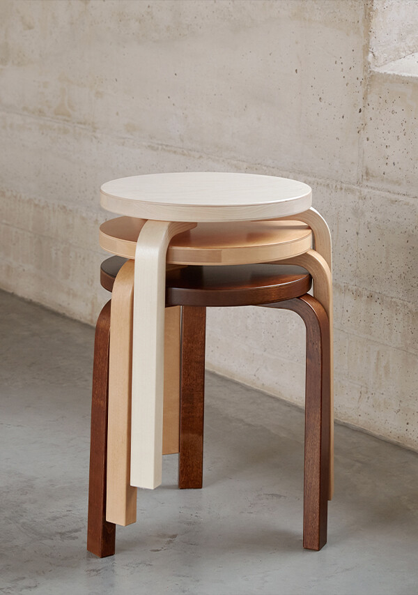 Stack of 3 Artek 60 Stools in different wooden finishes