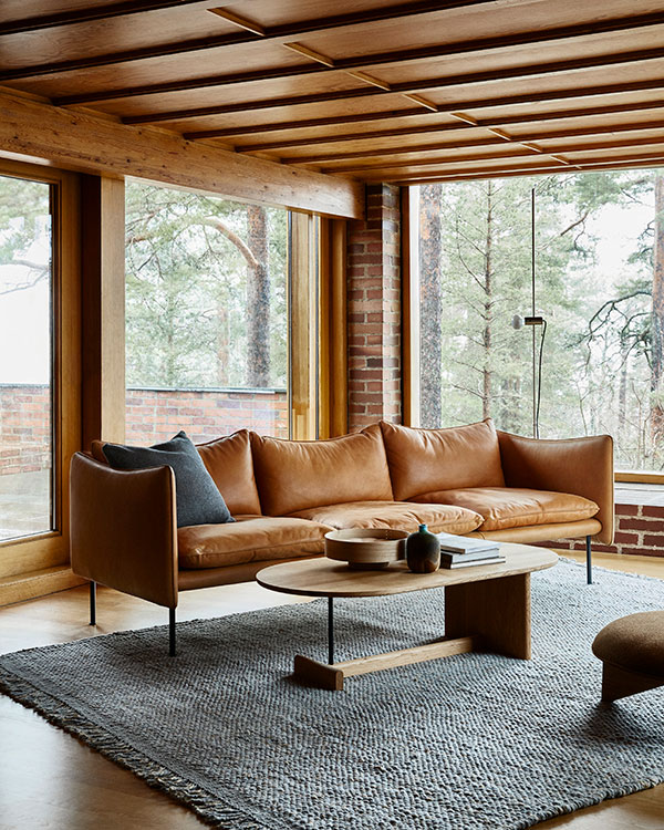 A brown leather Fogia Tiki sofa inside a mid-century home