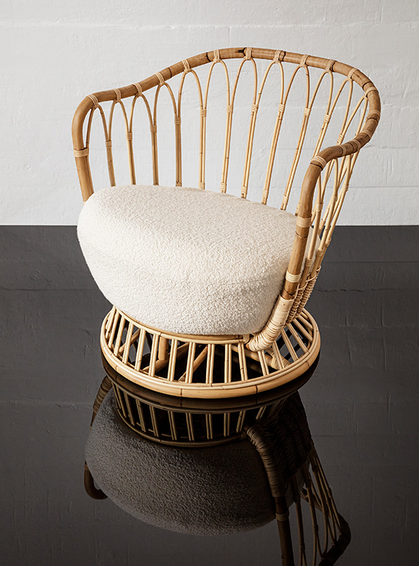 Rattan Gubi Grace Lounge Chair on a shiny black floor