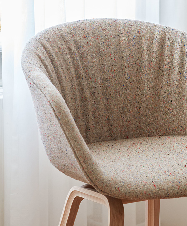 A close up of an upholstered HAY About A Chair