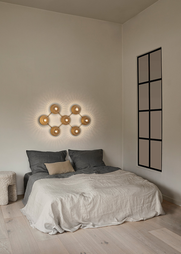 Nuura Liile 7 wall light above a bed