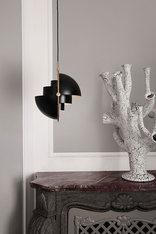 side view of a Gubi multi lite in brass and black