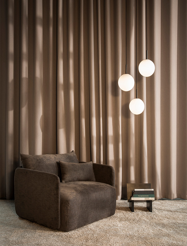 3 Audo TR bulb pendant lights next to a lounge chair