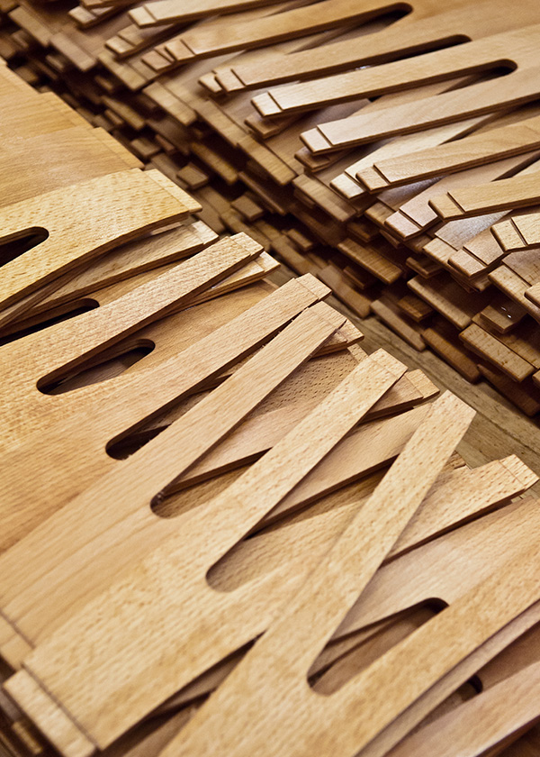 Pieces of a CH24 wishbone chair stacked up before assembly