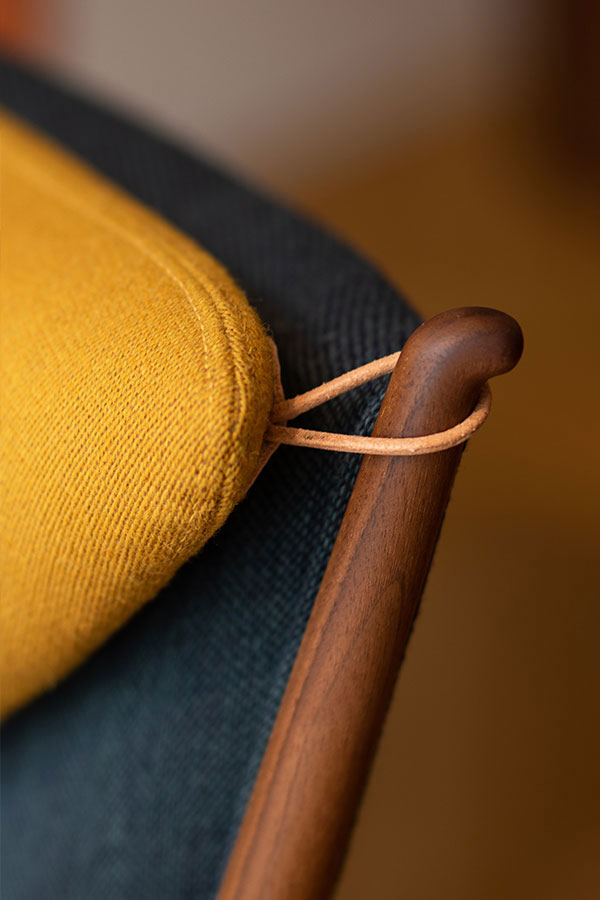 A detail of the cushion and frame on the House of Finn Juhl Whisky Chair