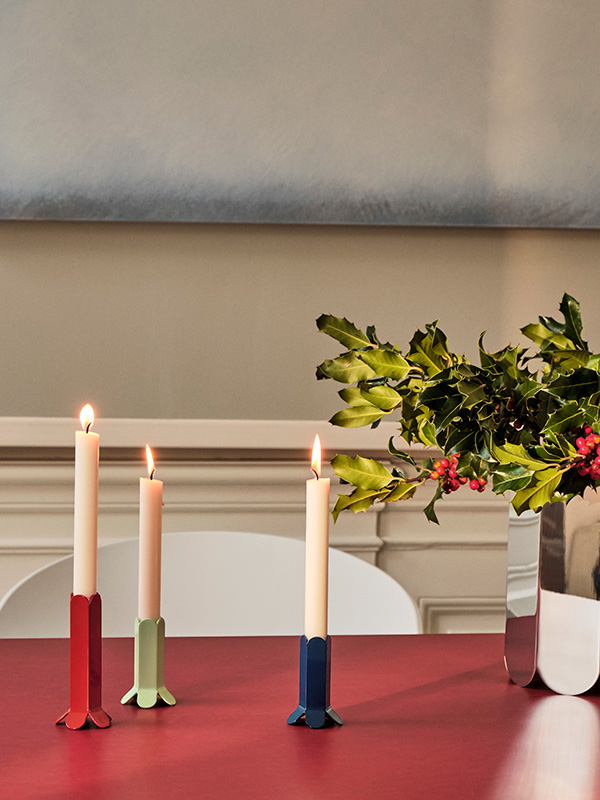 Three HAY Arcs candleholders on a red dining table