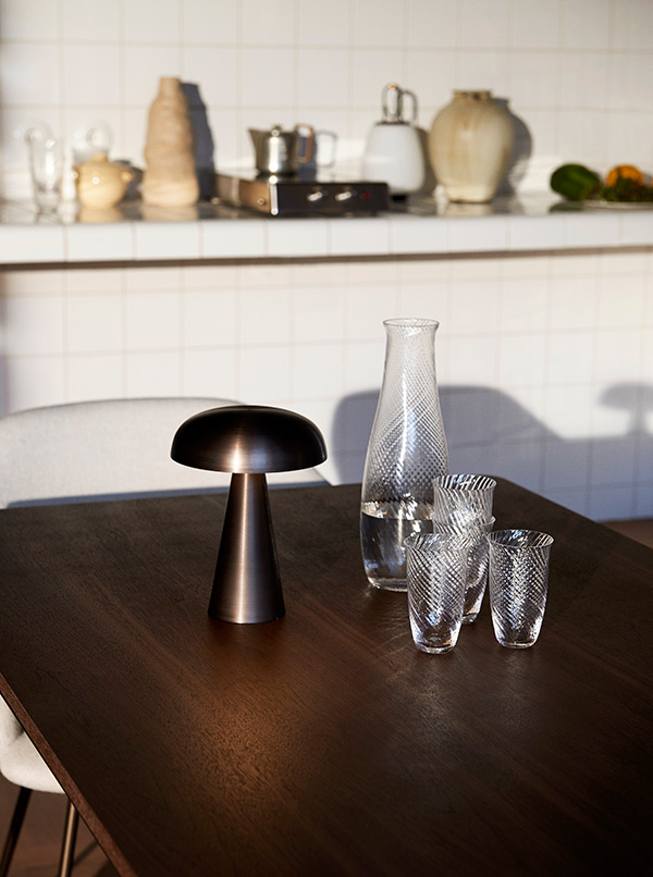 &Tradition Como portable table lamp and Collect glasses on a dark wood dining table