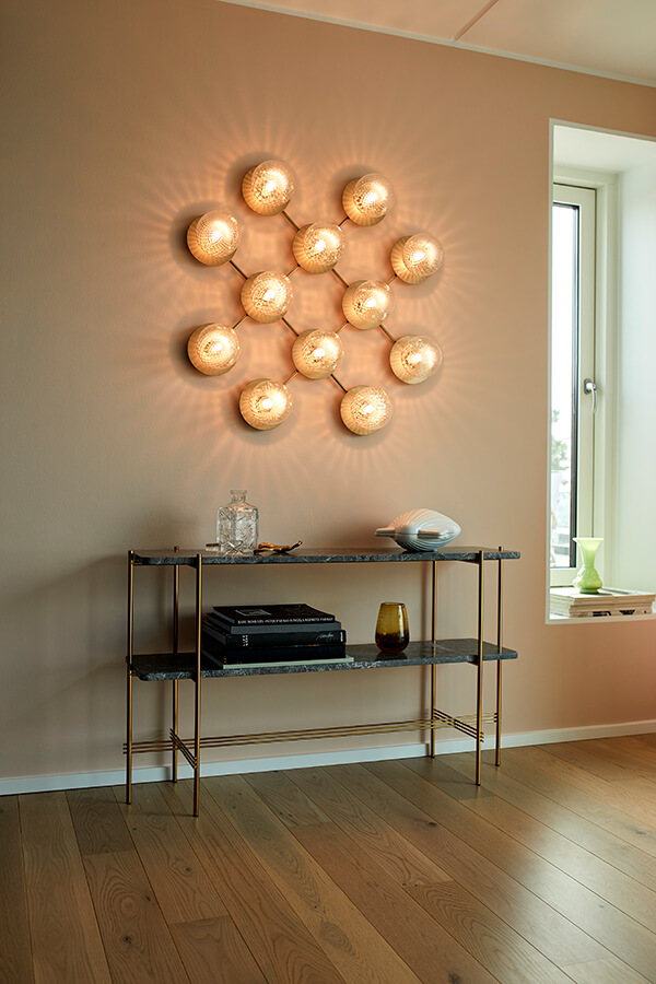 Nuura Liila 12 wall light above a shelving unit