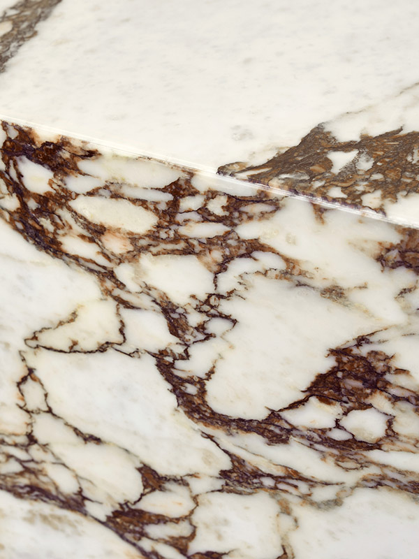 A close up of the details on menu's Calacatta Viola Marble plinth