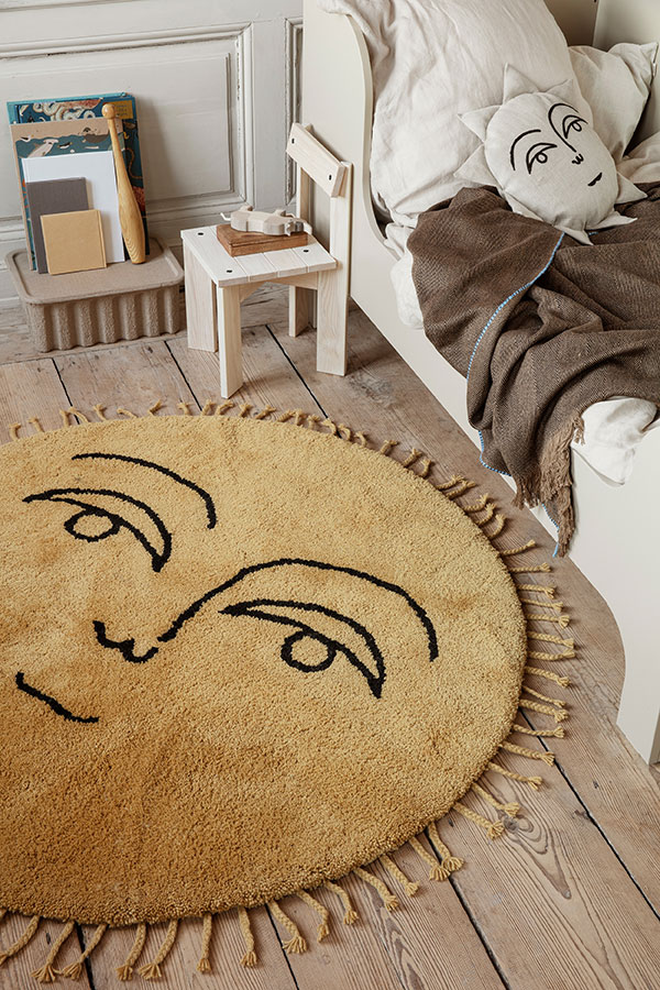 A ferm living sun tufted rug in a children's bedroom