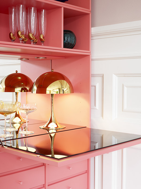 Louis Poulsen Panthella 250 mini in brass finish inside a pink drinks cabinet