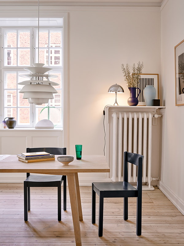 Panthella mini 250 chrome on a shelf in a neutral dining room