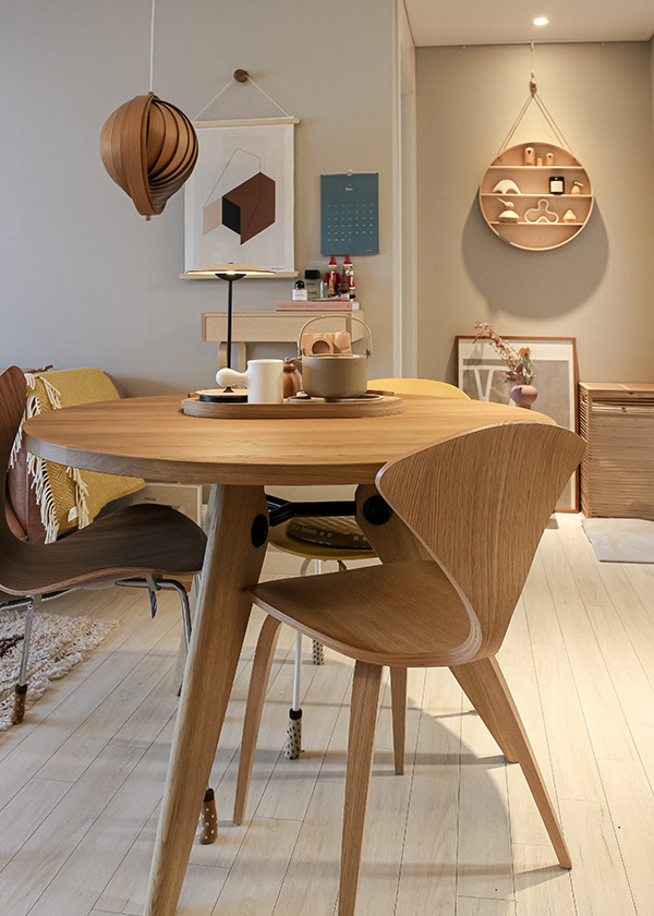 A dining table and chairs in a neutral Korean apartment