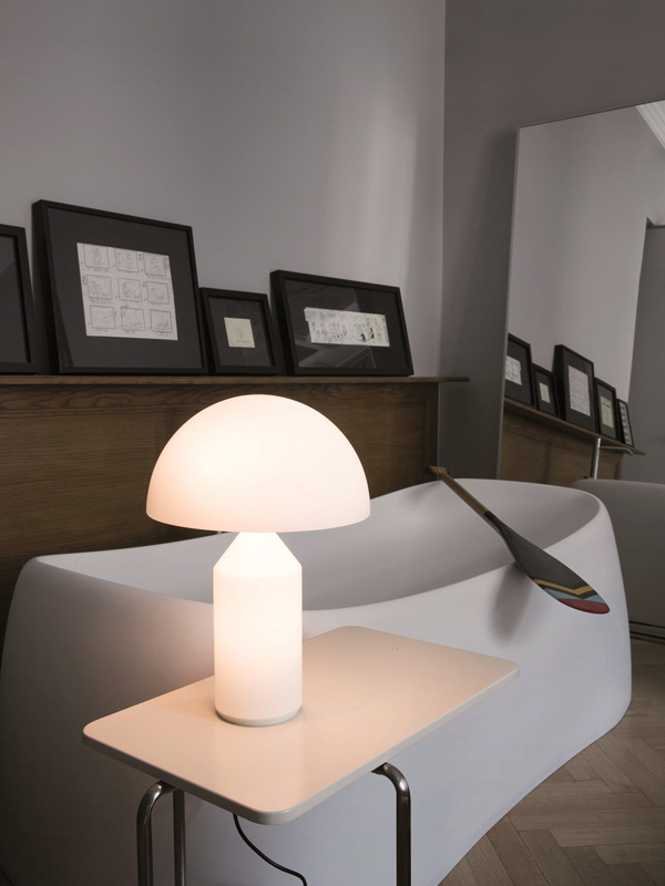 Oluce Atollo Table Lamp on a table next to a bath
