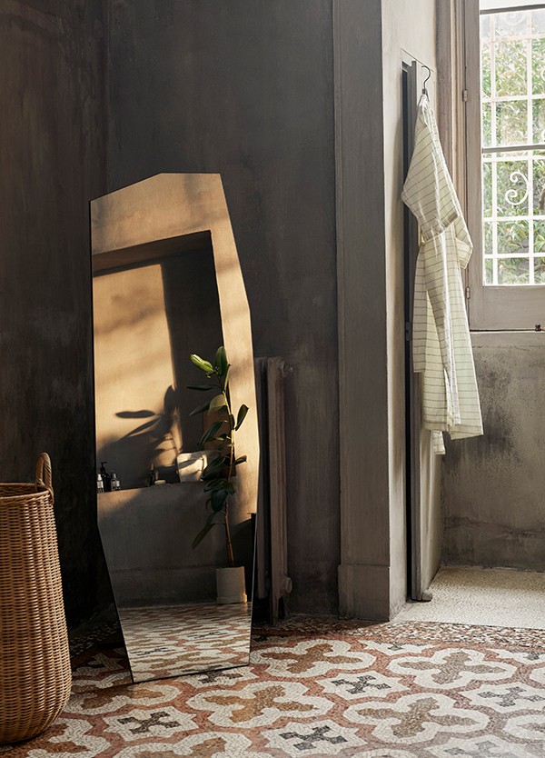 ferm LIVING Shard Free Standing Mirror placed in the corner of the room
