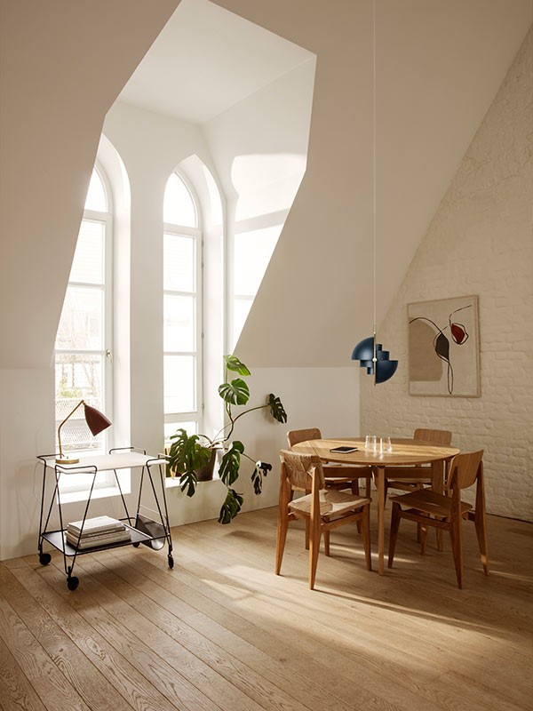 A single GUBI Multi-Lite suspended over a dining table