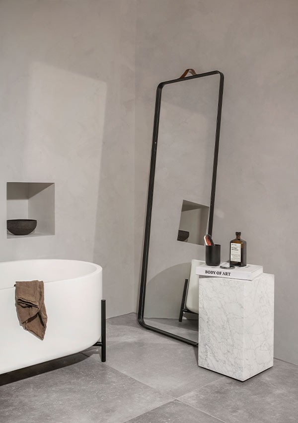 Contemporary bathroom with Audo Copenhagen Norm Floor Mirror leaning against wall