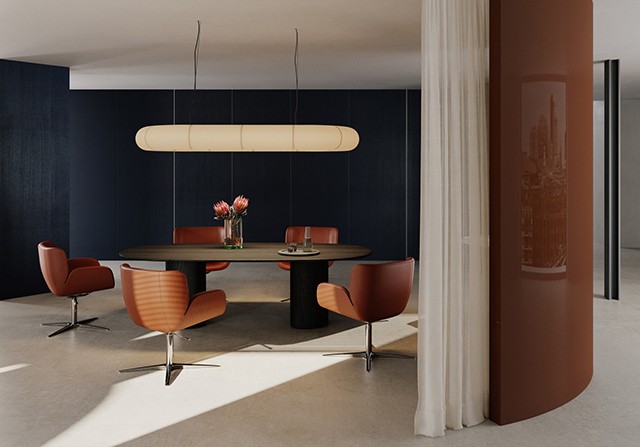 Dark wood oval conference table surrounded by rust-orange leather swivel armchairs in a modern office space.