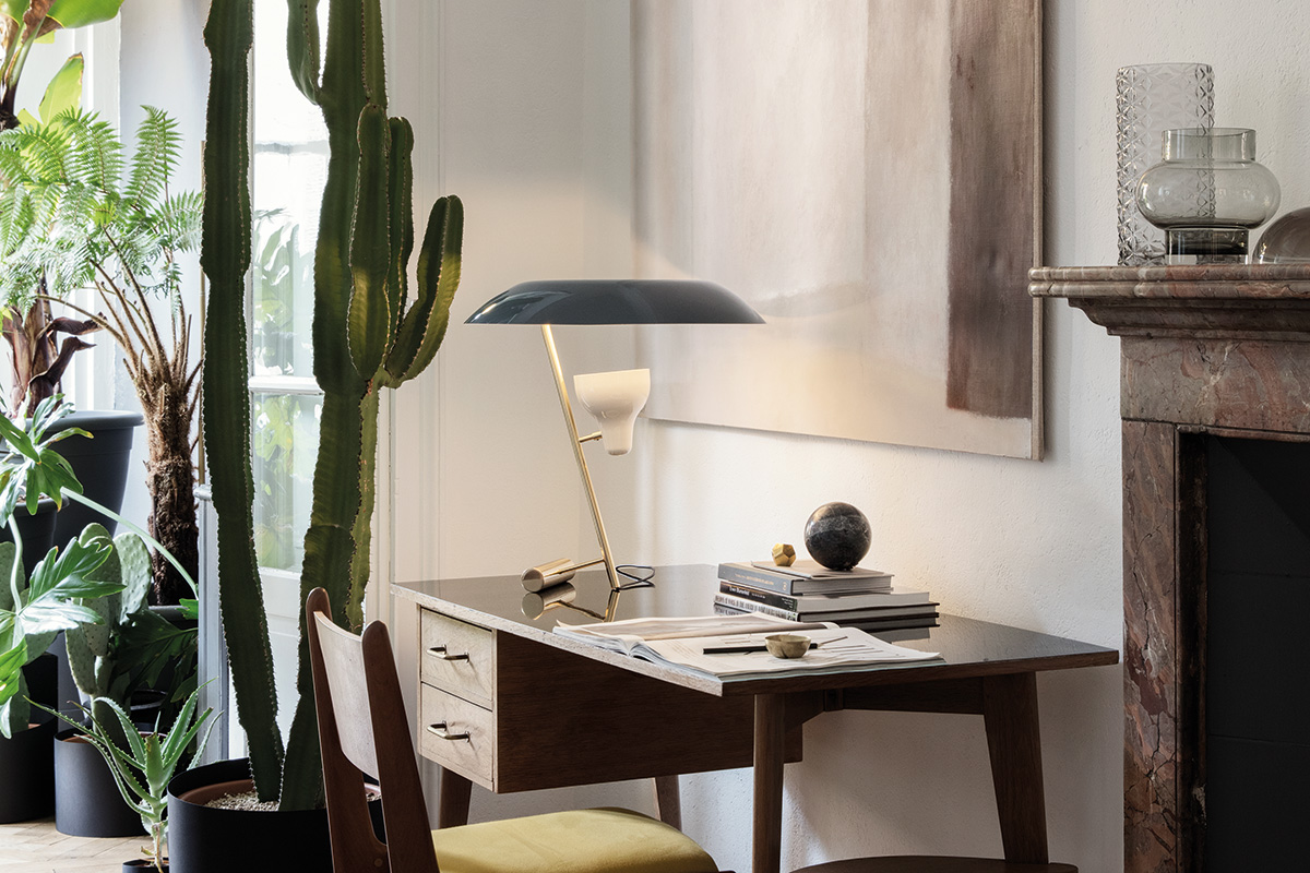 a blue Model 548 table lamp on a desk