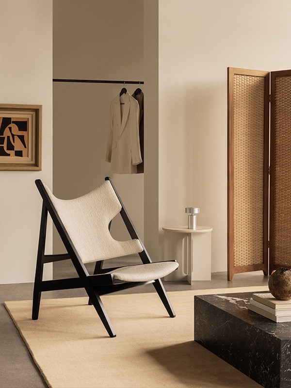 Audo Copenhagen Everyday Icons Knitting Chair in room setting with screen, Plinth Coffee Table and Column Portable Table Lamp