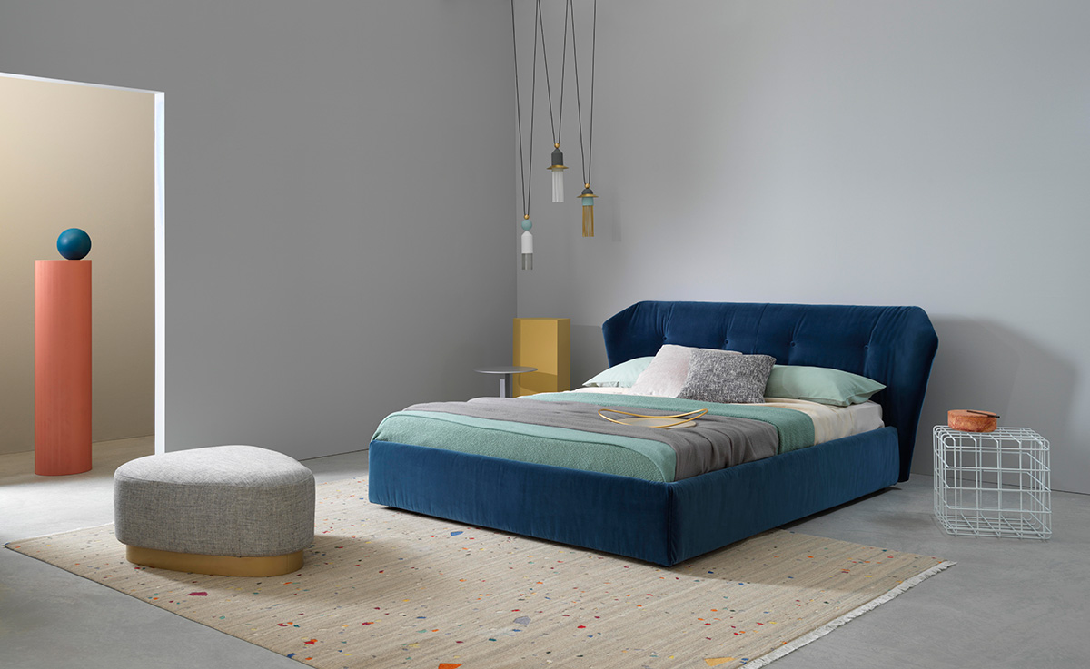 The blue Saba Italia New York Box bed in a grey studio room