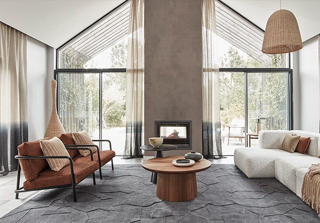 DARE Studio luxury contemporary sofa and coffee table layout in a bright modern living room.