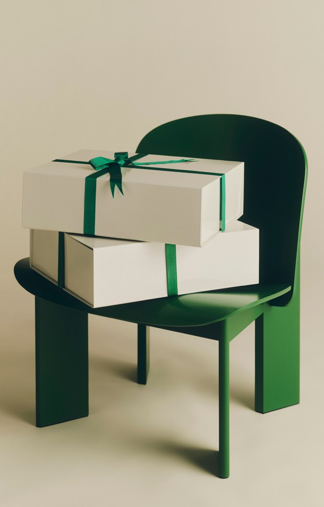 wrapped gifts on the HAY Chisel Chair in green