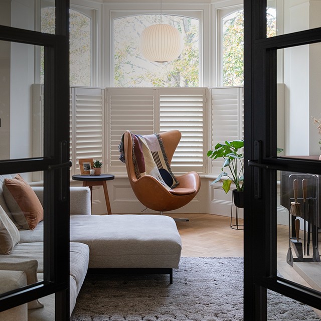 Image of Egg Chair in leather in modern living room through doorway