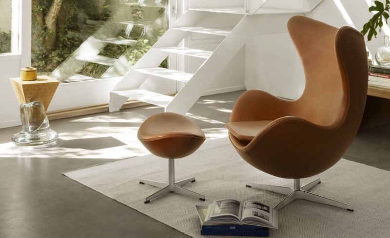 Tan Leather Egg Chair and Footstool on a white rug