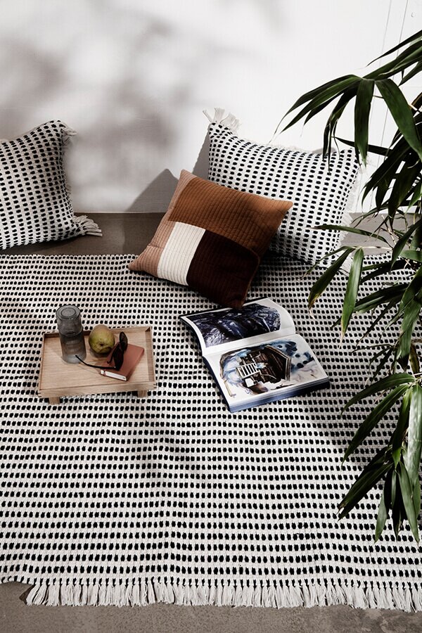 Ferm living Way Rug with cushions and a magazine