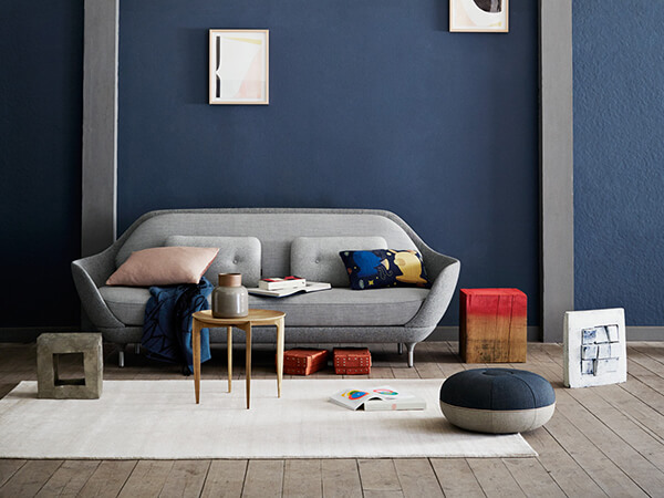 Light grey Fritz Hansen Favn Sofa in dark blue interior