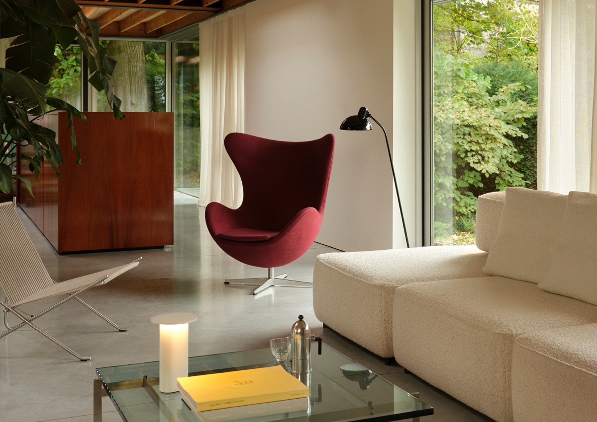 Fritz Hansen Egg Chair in dark red fabric in luxury interior