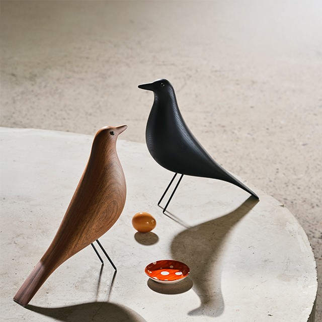 Eames Bird in Walnut and Black pictured together on concrete with shadows