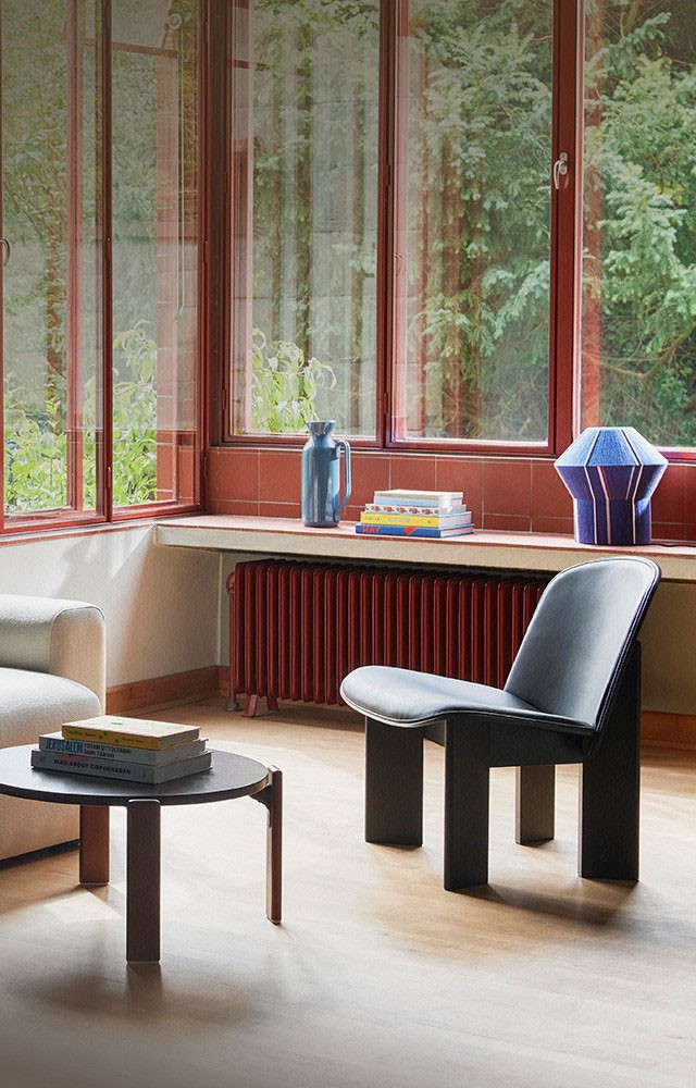 light grey 3 seater sofa with a coffee table and lounge chair on a wooden floor