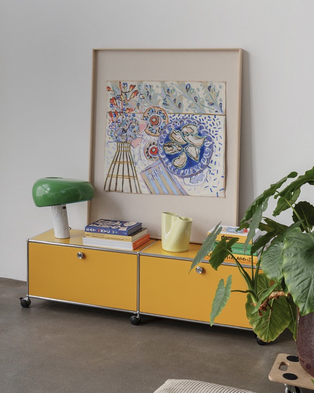 USM Haller Sideboard with FLOS Snoopy and colourful artwork in living room setting 