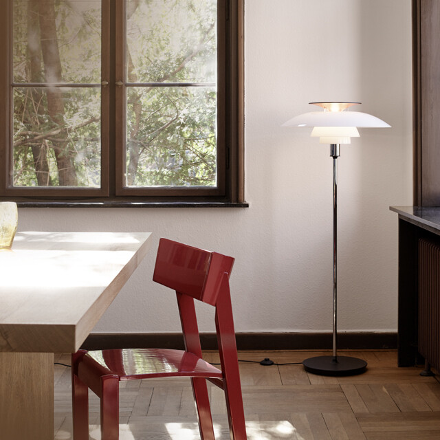 Louis Poulsen PH 80 Floor Lamp in original opal and chrome finish in the corner of a dining room with wooden flooring. 