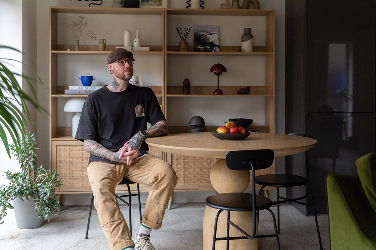 Portrait image of Liam Rimmington sitting at a dining table in his home