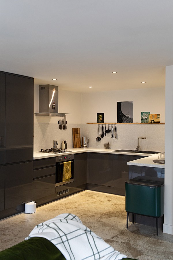 A modern kitchen space with grey cupboards