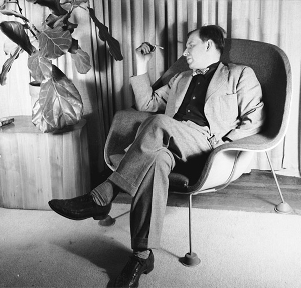 Eero Saarinen sitting in an early prototype of the Womb Chair