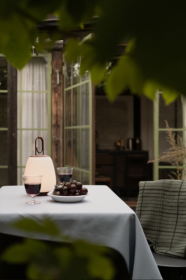 Outdoor table setting with &Tradition SC51 Lucca Portable Table Lamp