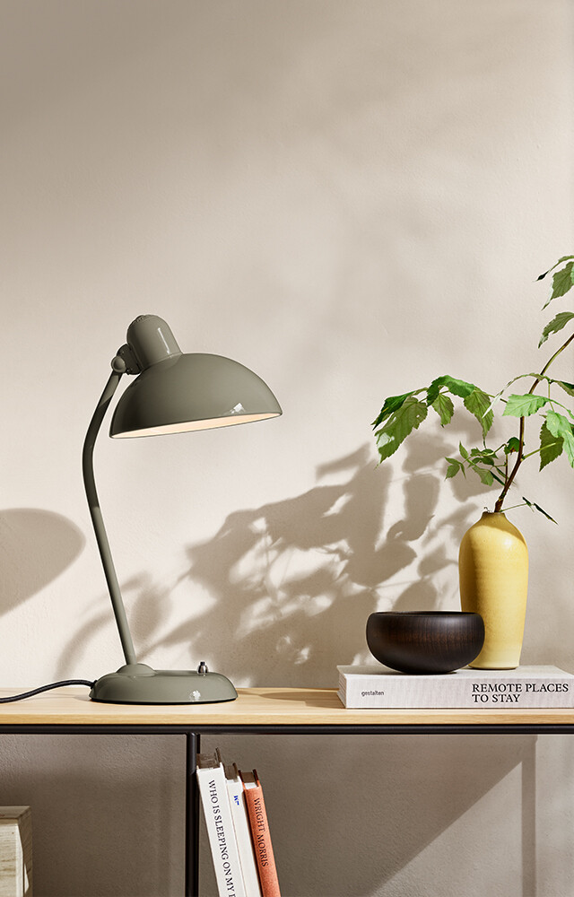 Fritz Hansen Kaiser Idell 6556-T Table Lamp in new Olive Green finish on wooden sideboard with plants 
